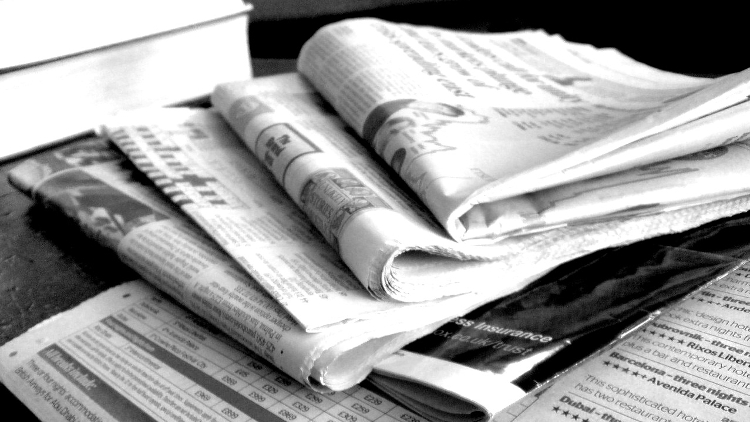 Newspapers in black and white.